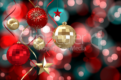 Composite image of hanging christmas bauble decorations