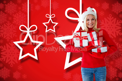 Composite image of happy festive blonde with gift