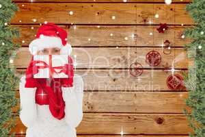 Composite image of festive woman holding gift