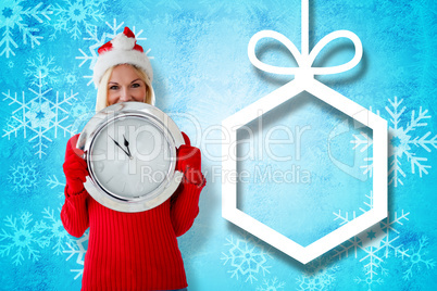 Composite image of happy festive blonde with clock