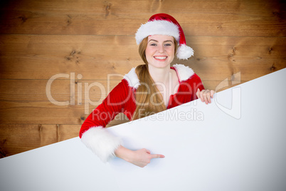 Composite image of pretty girl in santa costume showing card