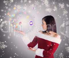 Composite image of pretty girl presenting in santa outfit