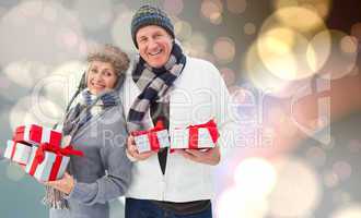 Composite image of festive mature couple holding christmas gifts