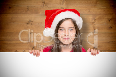 Composite image of festive little girl showing card