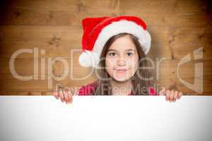 Composite image of festive little girl showing card