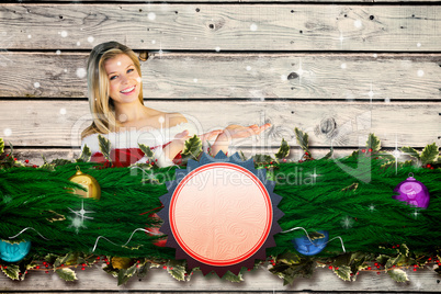 Composite image of pretty girl presenting in santa outfit