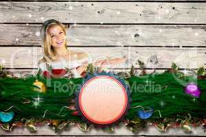 Composite image of pretty girl presenting in santa outfit