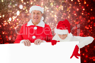 Composite image of festive couple showing poster