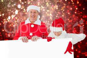 Composite image of festive couple showing poster