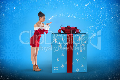 Composite image of pretty santa girl blowing over her hands