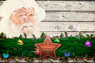 Composite image of santa claus winking