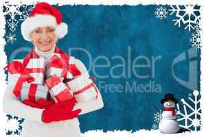 Composite image of festive woman holding gifts