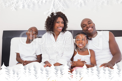 Happy family having breakfast in bed