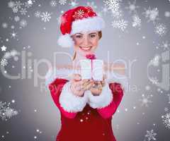 Composite image of pretty girl in santa costume holding gift box