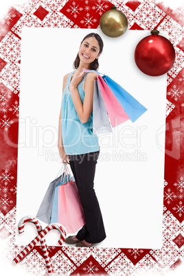 Composite image of portrait of a woman posing with shopping bags