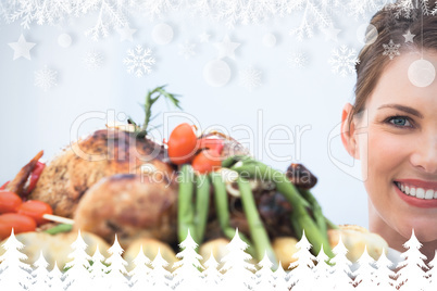Composite image of smiling woman showing roast chicken