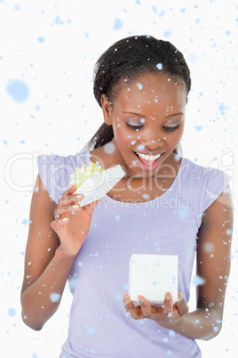 Composite image of close up of woman being happy about a present
