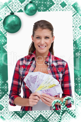 Composite image of portrait of a woman holding bank notes