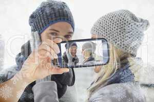 Hand holding smartphone showing photo