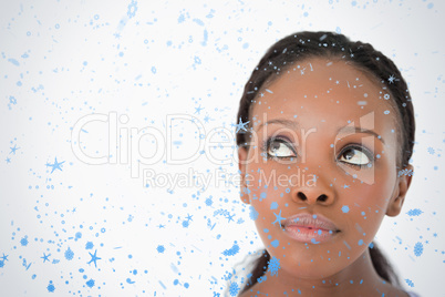 Close up of womans face looking upwards diagonally on white back