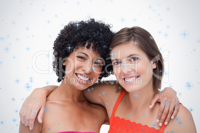 Two smiling friends holding each other by the shoulder