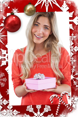 Composite image of blonde woman receiving a gift