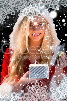 Pretty blonde in santa outfit opening gift