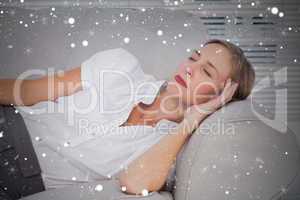 Composite image of businesswoman sleeping on couch