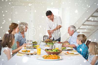 Composite image of father serving meal to family