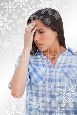 Woman with a headache and hand on forehead