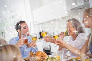Family raising their glasses at thanksgiving dinner