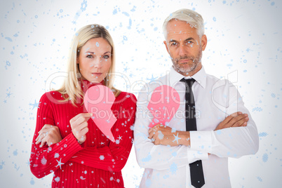 Couple not talking holding two halves of broken heart