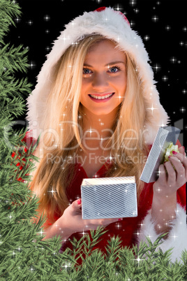 Pretty blonde in santa outfit opening gift