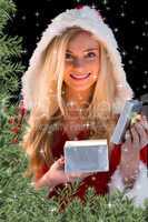 Pretty blonde in santa outfit opening gift