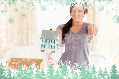 Beautiful woman holding model house and keys