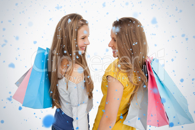 Rear view of two young women with shopping bags