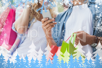 Cute young couple on shopping trip looking at smartphone