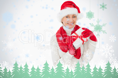 Festive woman smiling at camera holding a gift