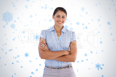 Smiling businesswoman standing alone with her arms crossed