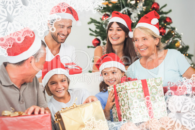 Composite image of happy family at christmas swapping gifts