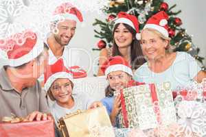 Composite image of happy family at christmas swapping gifts