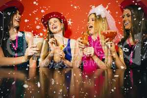 Composite image of laughing friends at a hen night drinking cock
