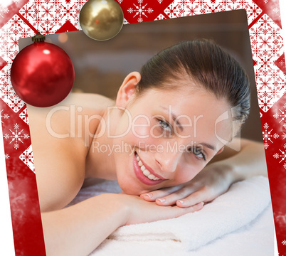 Beautiful woman lying on massage table at spa center