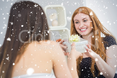 Composite image of beautiful young blond receiving a gift box on