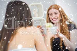Composite image of beautiful young blond receiving a gift box on