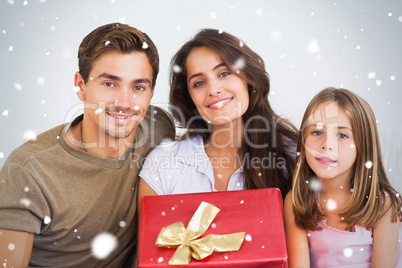 Composite image of father and his daughter offering a gift to he