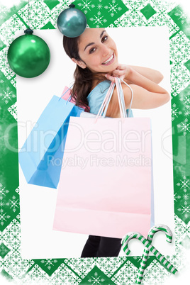 Composite image of portrait of a smiling woman posing with shopp
