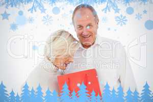 Older couple holding red gift bag