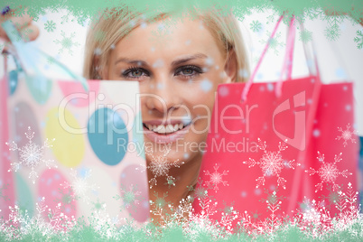 Smiling blonde showing her shopping bags