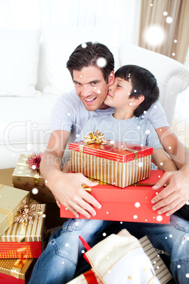 Composite image of son kissing his father after receiving a chri
